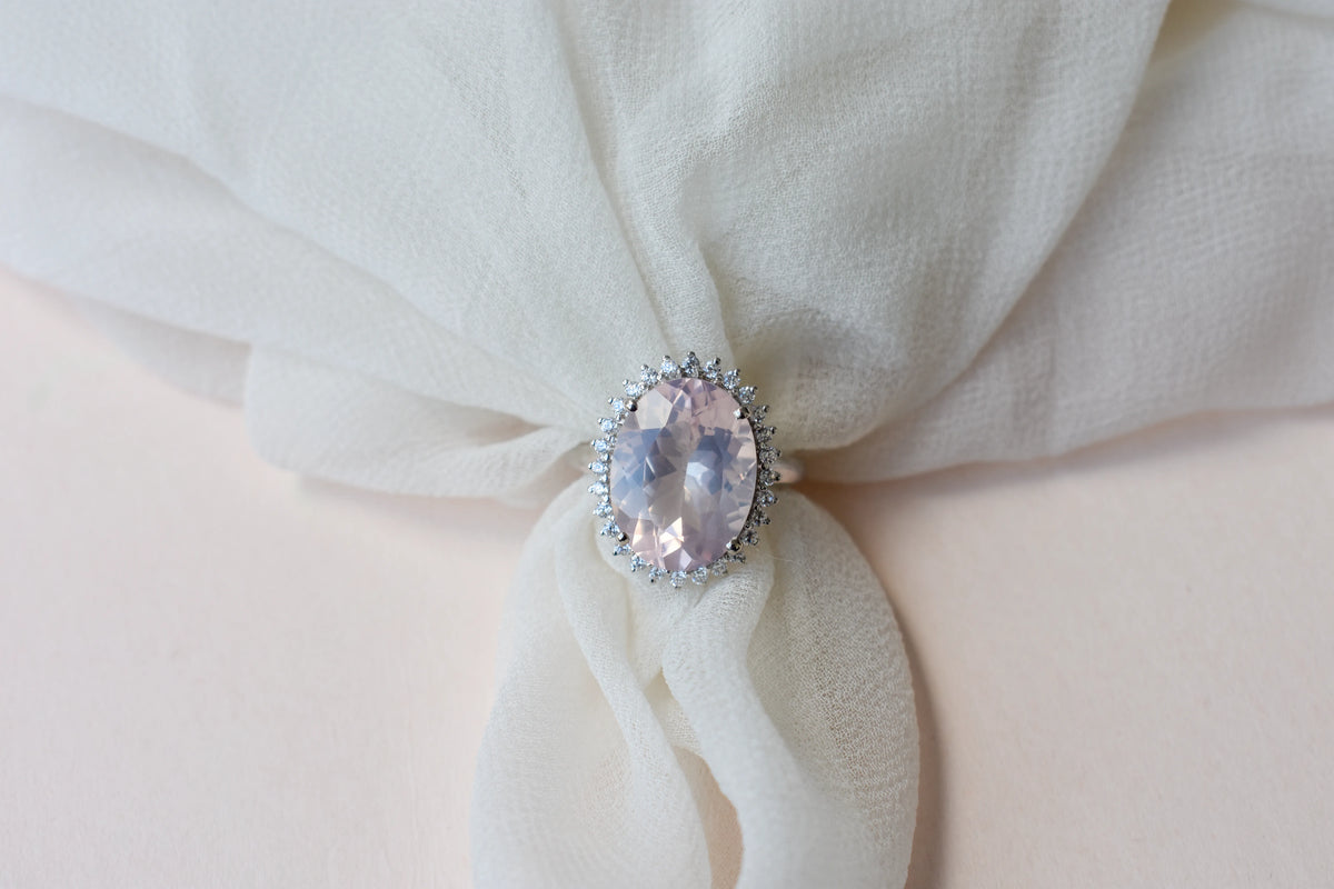 Oval rose quartz halo ring in 925 silver with cubic zirconia accents