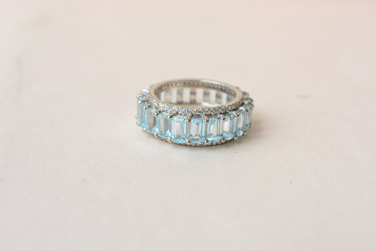 Sky blue topaz emerald-cut eternity ring in 925 silver