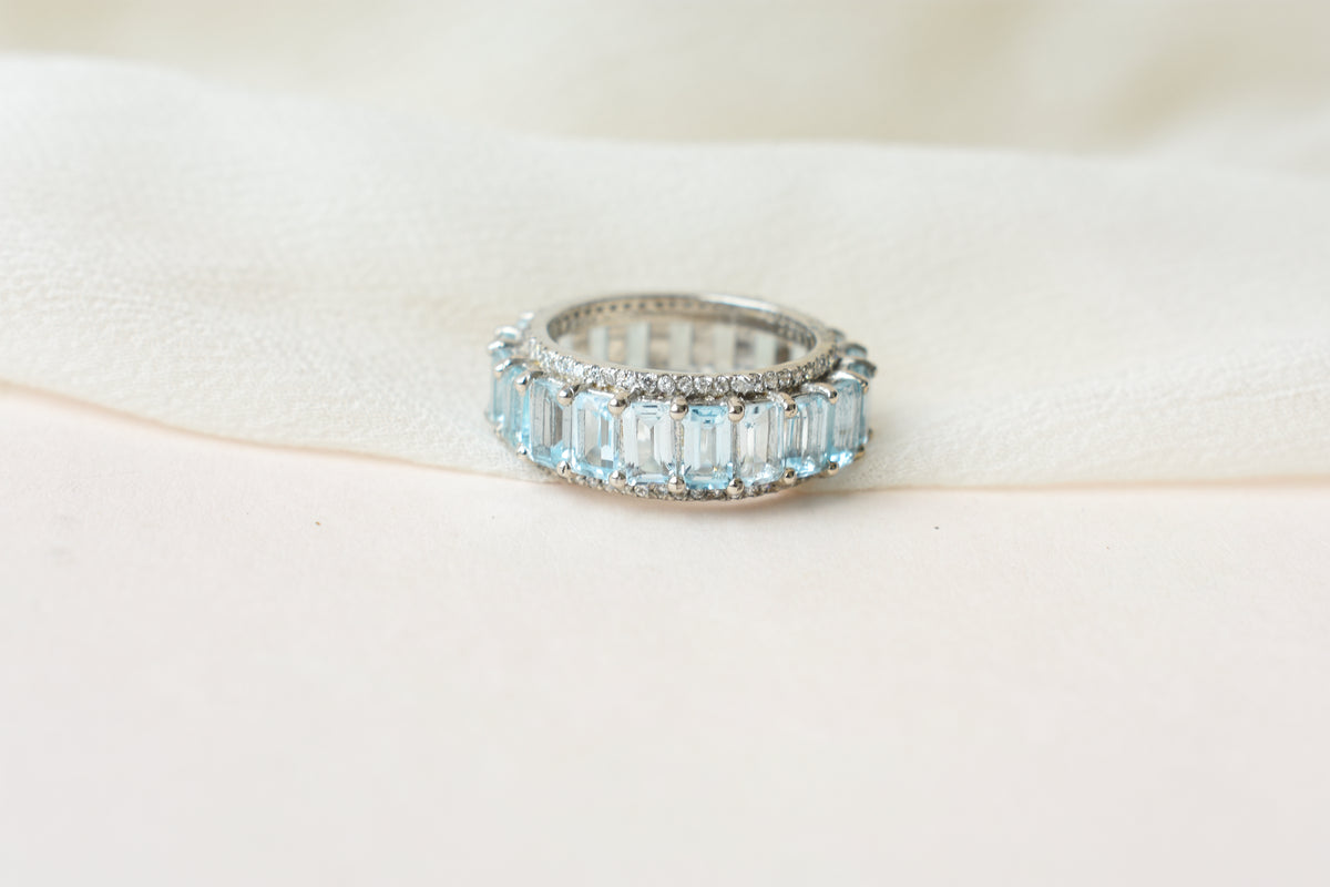 Sky blue topaz emerald-cut eternity ring in 925 silver