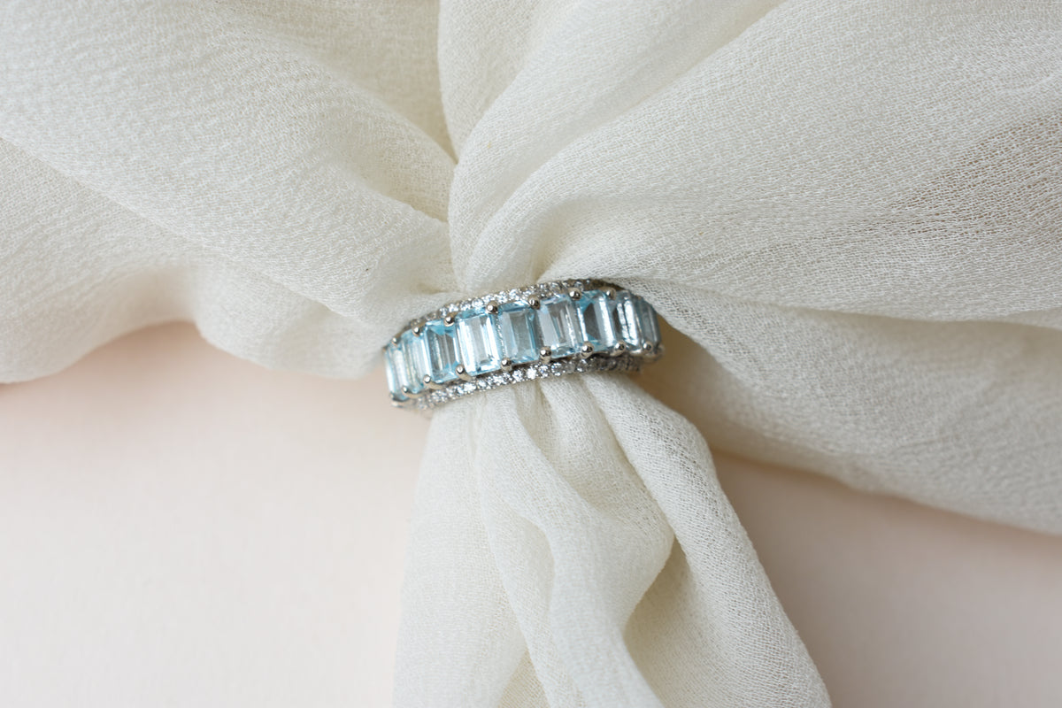 Sky blue topaz emerald-cut eternity ring in 925 silver