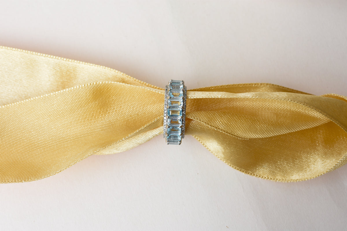 Sky blue topaz emerald-cut eternity ring in 925 silver