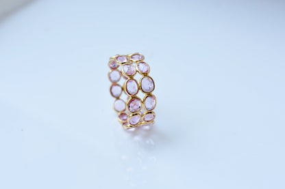 Oval-cut pink sapphire double-row eternity ring in 18K gold