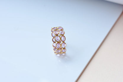 Oval-cut pink sapphire double-row eternity ring in 18K gold