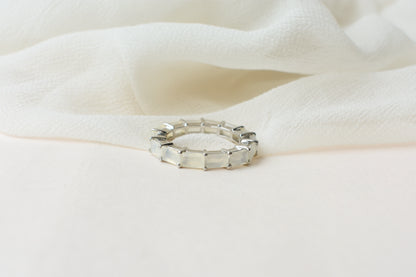 Opalescent white baguette eternity ring in 925 silver