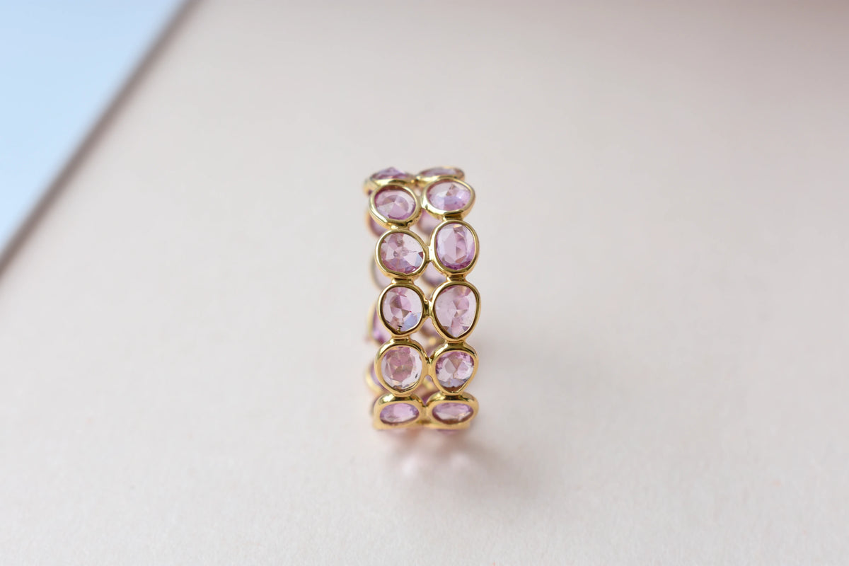 Oval-cut pink sapphire double-row eternity ring in 18K gold
