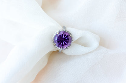 Round amethyst halo ring in 925 silver with fan-faceted cut and cubic zirconia border