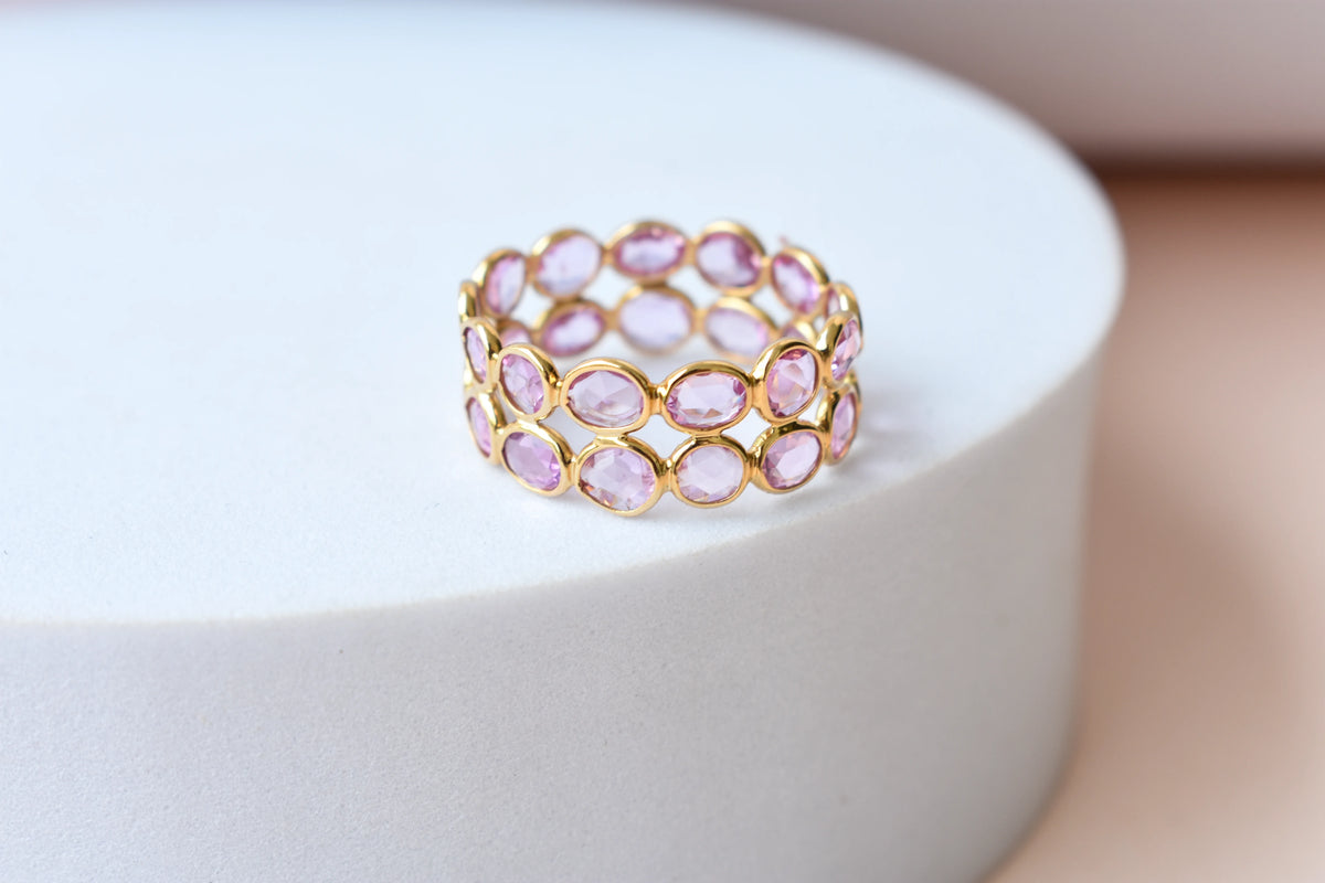 Oval-cut pink sapphire double-row eternity ring in 18K gold