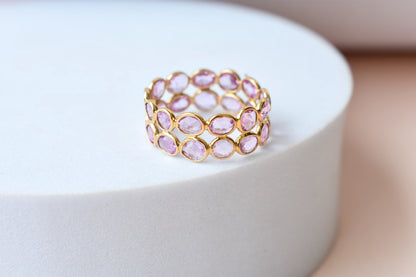 Oval-cut pink sapphire double-row eternity ring in 18K gold