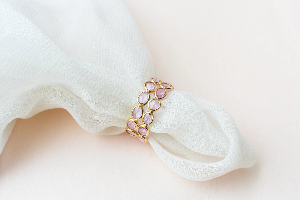 Oval-cut pink sapphire double-row eternity ring in 18K gold