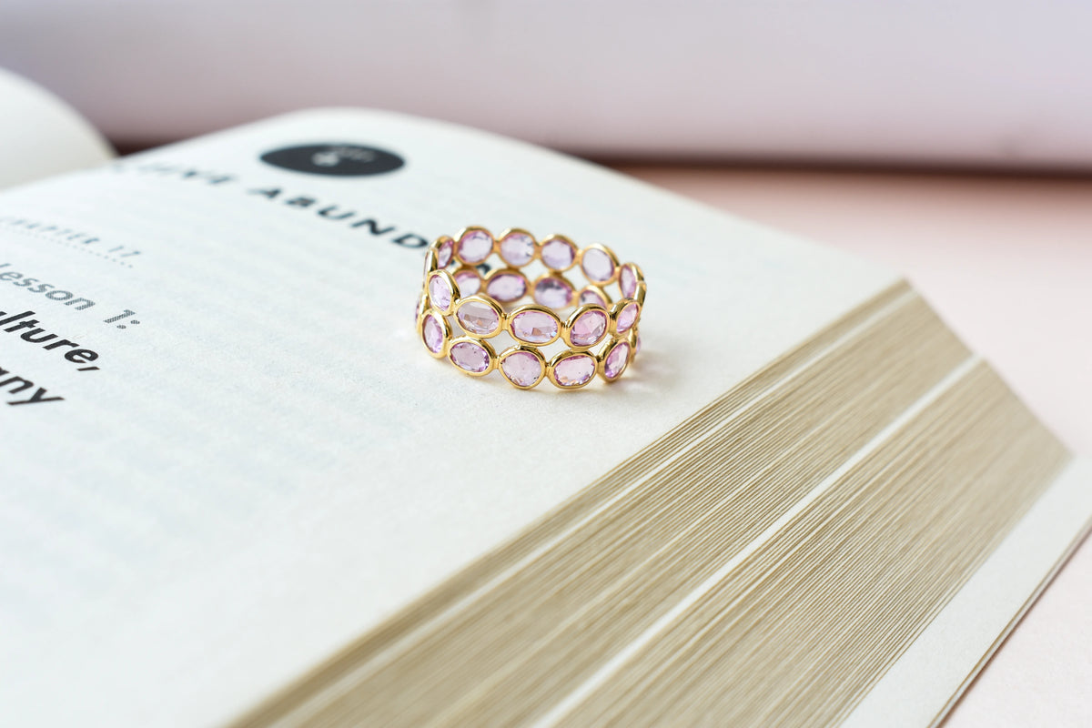 Oval-cut pink sapphire double-row eternity ring in 18K gold