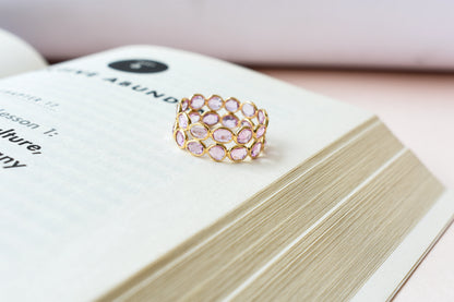 Oval-cut pink sapphire double-row eternity ring in 18K gold