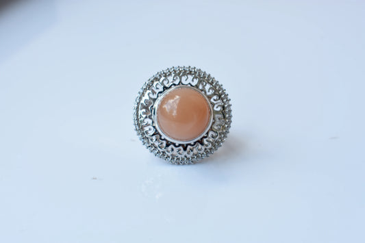 Peach moonstone cabochon ring in 925 silver with ornate scrollwork setting