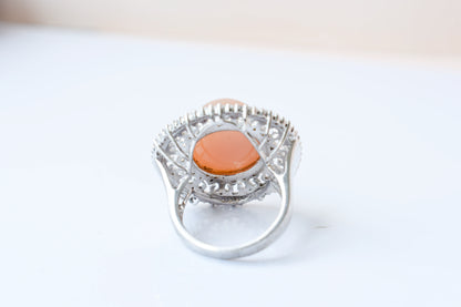 Peach moonstone cabochon ring in 925 silver with ornate scrollwork setting