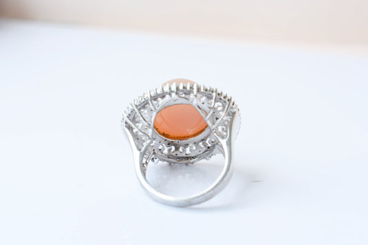Peach moonstone cabochon ring in 925 silver with ornate scrollwork setting