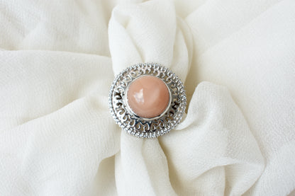 Peach moonstone cabochon ring in 925 silver with ornate scrollwork setting