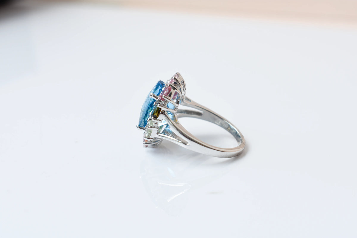 Swiss blue topaz ring with multicolor tourmaline halo in 925 silver