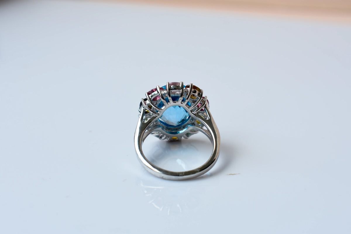 Swiss blue topaz ring with multicolor tourmaline halo in 925 silver