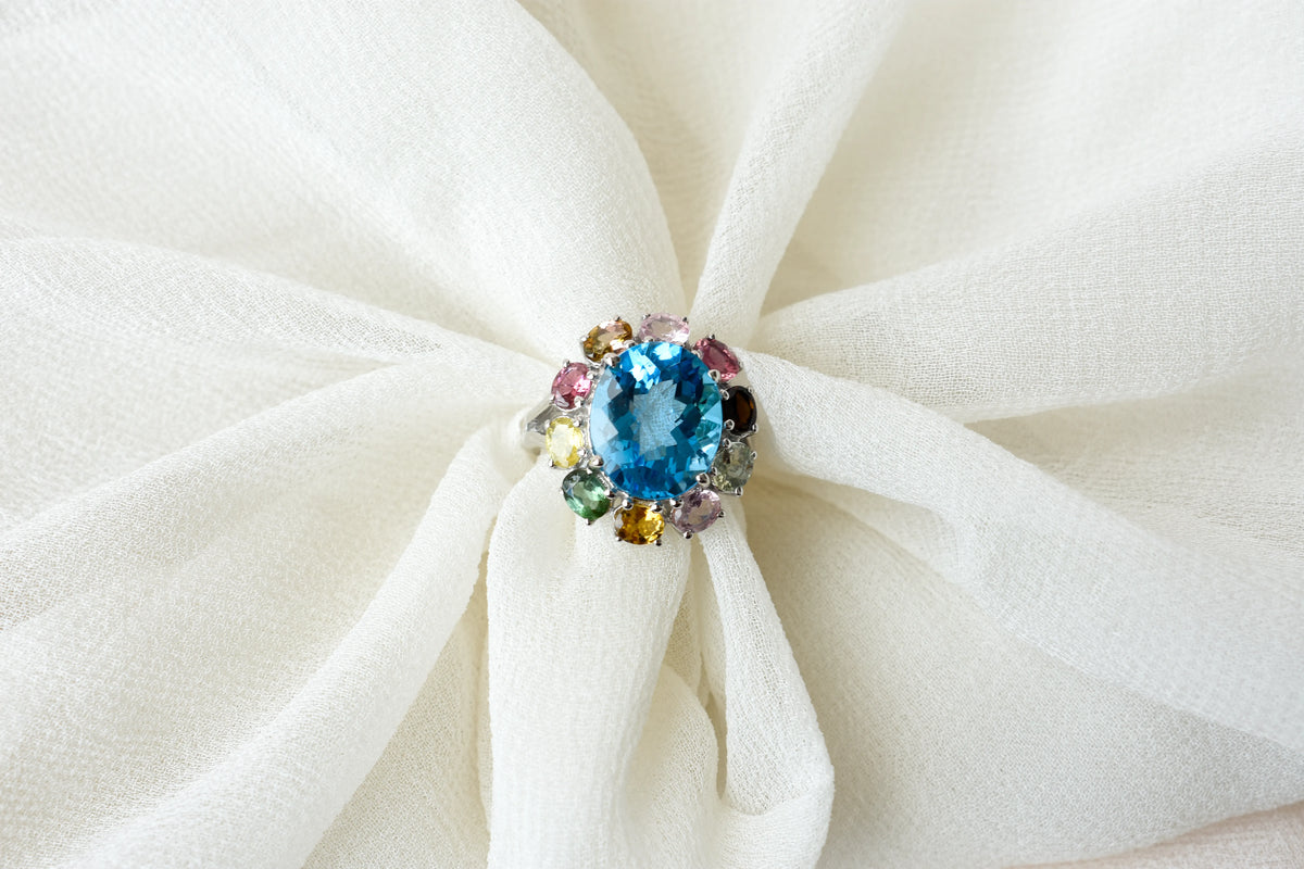 Swiss blue topaz ring with multicolor tourmaline halo in 925 silver