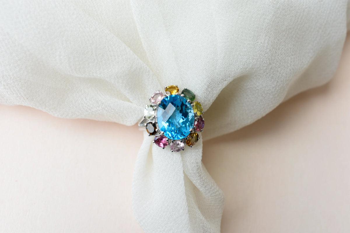 Swiss blue topaz ring with multicolor tourmaline halo in 925 silver