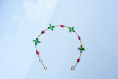 18K gold bracelet with emerald quatrefoil clusters and ruby drops