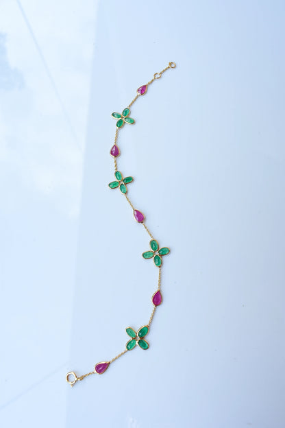 18K gold bracelet with emerald quatrefoil clusters and ruby drops