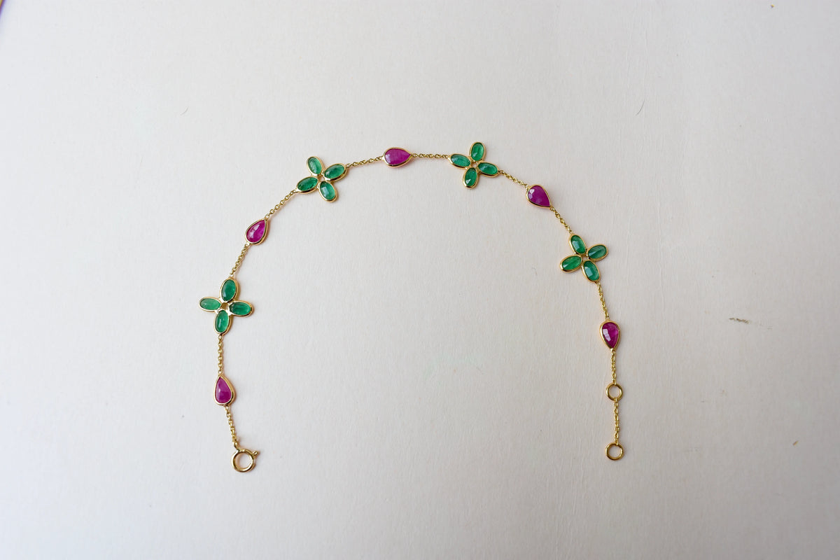 18K gold bracelet with emerald quatrefoil clusters and ruby drops