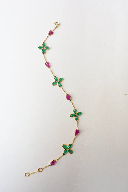 18K gold bracelet with emerald quatrefoil clusters and ruby drops