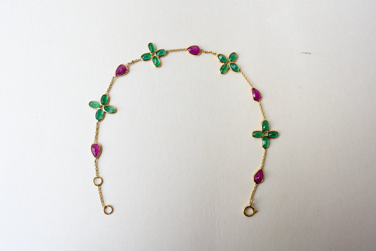 18K gold bracelet with emerald quatrefoil clusters and ruby drops