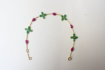 18K gold bracelet with emerald quatrefoil clusters and ruby drops