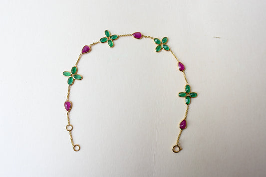 18K gold bracelet with emerald quatrefoil clusters and ruby drops