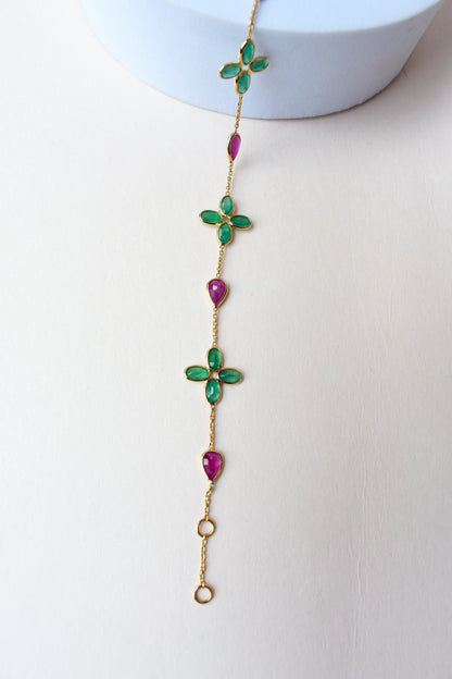 18K gold bracelet with emerald quatrefoil clusters and ruby drops