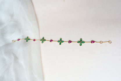 18K gold bracelet with emerald quatrefoil clusters and ruby drops