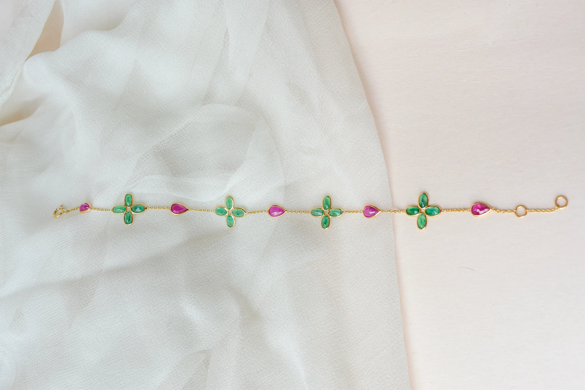 18K gold bracelet with emerald quatrefoil clusters and ruby drops