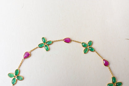 18K gold bracelet with emerald quatrefoil clusters and ruby drops