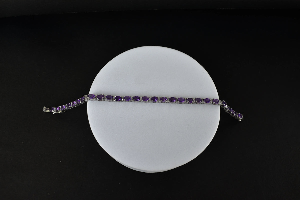 Oval-cut amethyst tennis bracelet with cubic zirconia accents in 925 silver