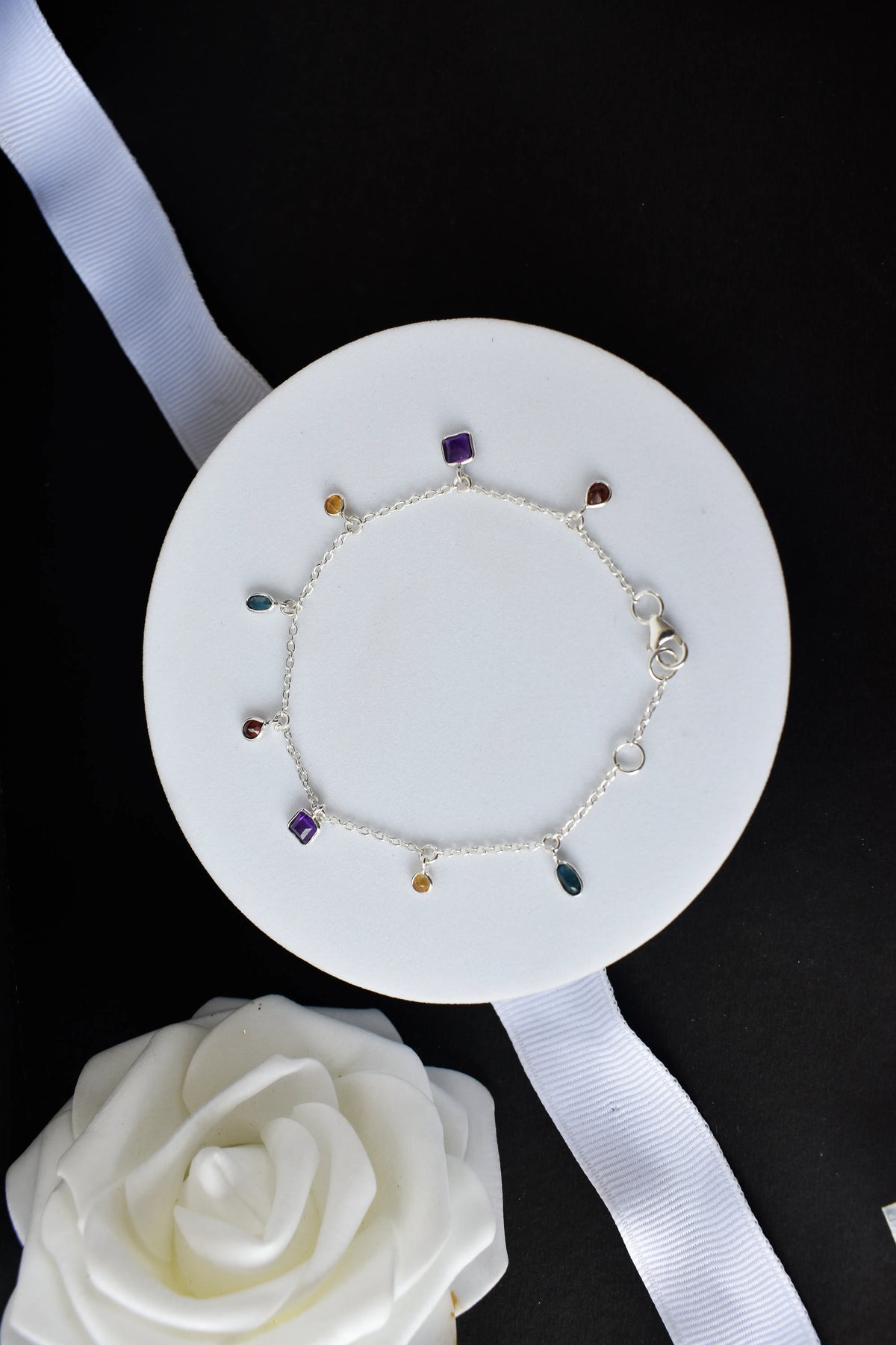 Multi gemstone charm bracelet with mixed-cut colored stones on a 925 silver chain