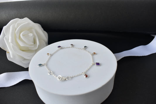Multi gemstone charm bracelet with mixed-cut colored stones on a 925 silver chain
