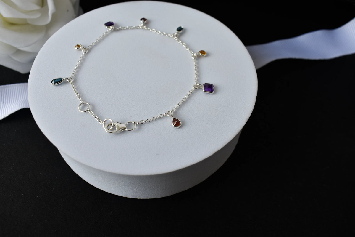 Multi gemstone charm bracelet with mixed-cut colored stones on a 925 silver chain