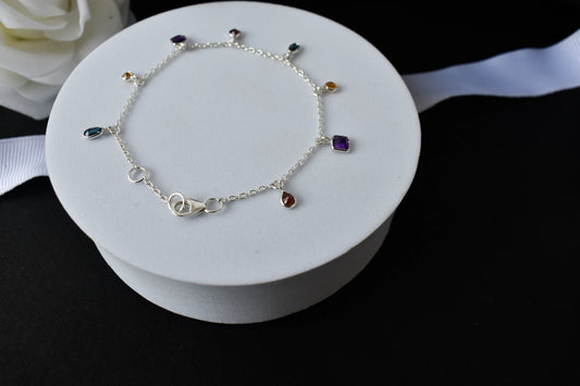 Multi gemstone charm bracelet with mixed-cut colored stones on a 925 silver chain