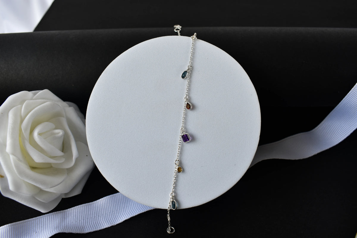Multi gemstone charm bracelet with mixed-cut colored stones on a 925 silver chain