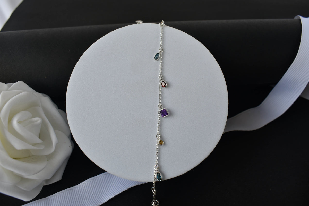 Multi gemstone charm bracelet with mixed-cut colored stones on a 925 silver chain