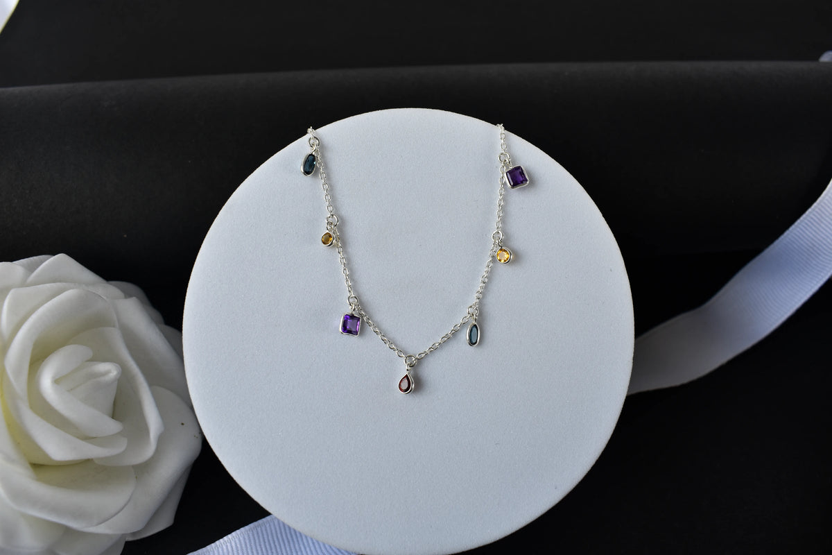 Multi gemstone charm bracelet with mixed-cut colored stones on a 925 silver chain