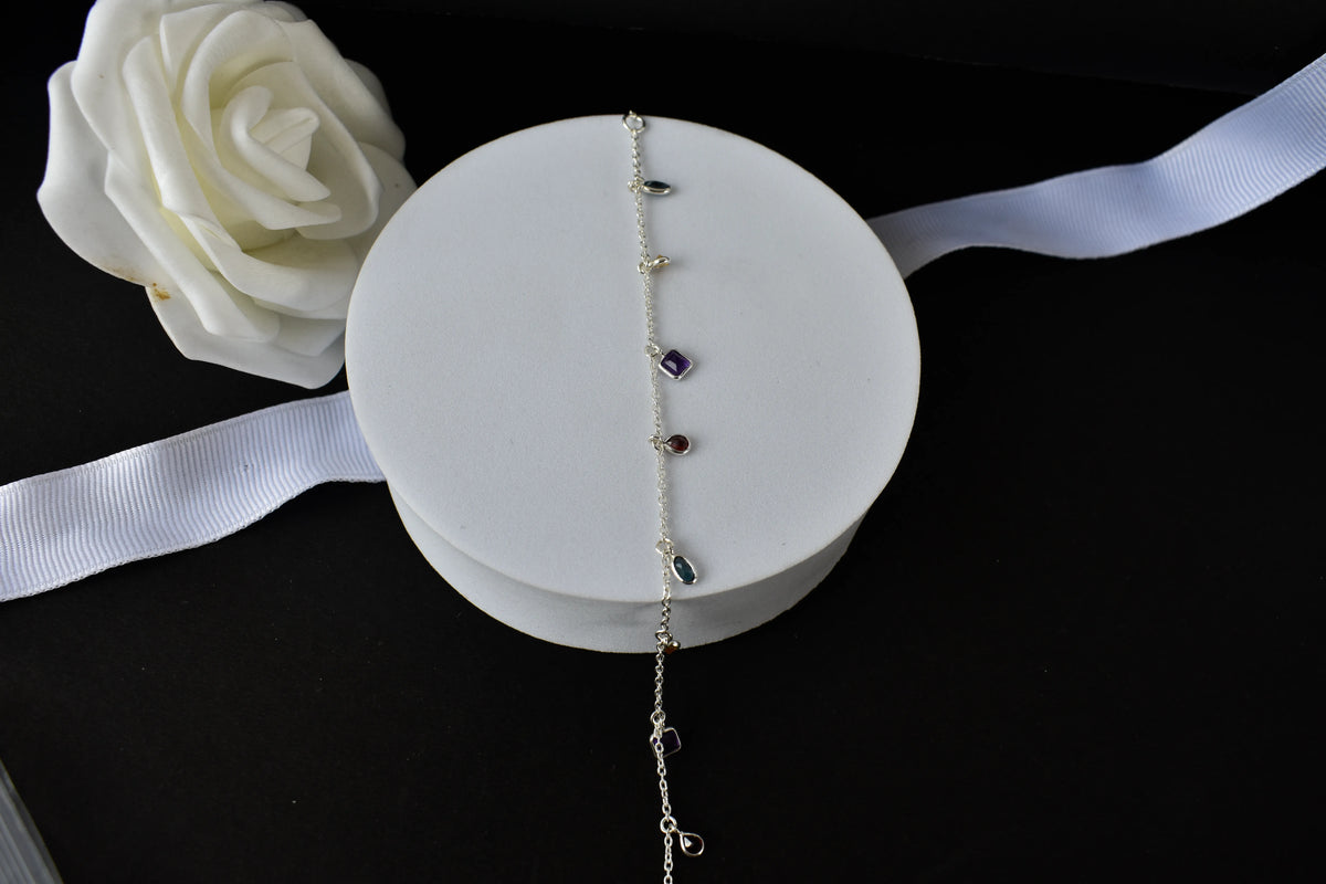 Multi gemstone charm bracelet with mixed-cut colored stones on a 925 silver chain