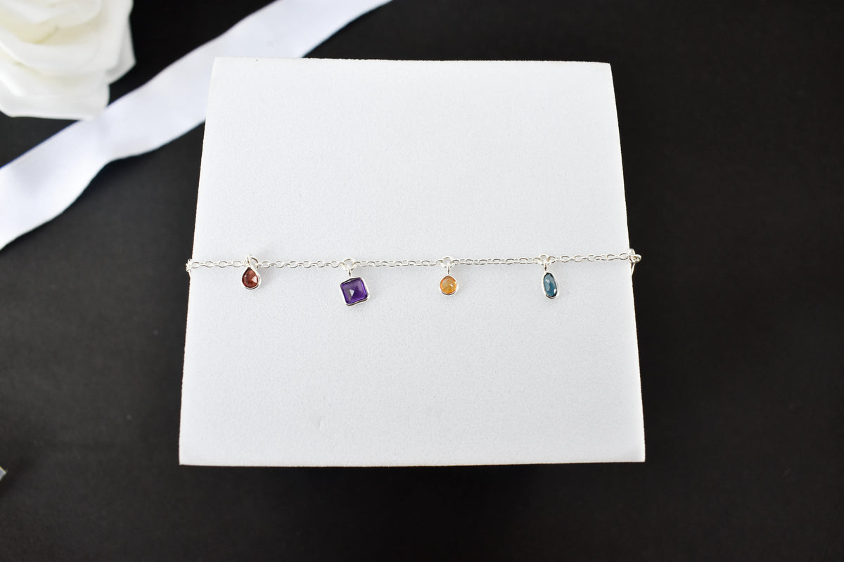 Multi gemstone charm bracelet with mixed-cut colored stones on a 925 silver chain