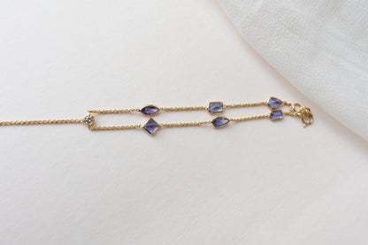 18K gold hand chain with tanzanite ring and diamond wrist accents