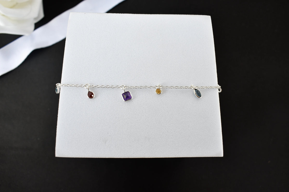 Multi gemstone charm bracelet with mixed-cut colored stones on a 925 silver chain