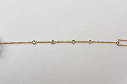 18K gold hand chain with tanzanite ring and diamond wrist accents