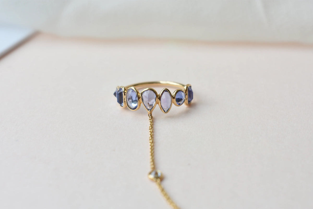 18K gold hand chain with tanzanite ring and diamond wrist accents