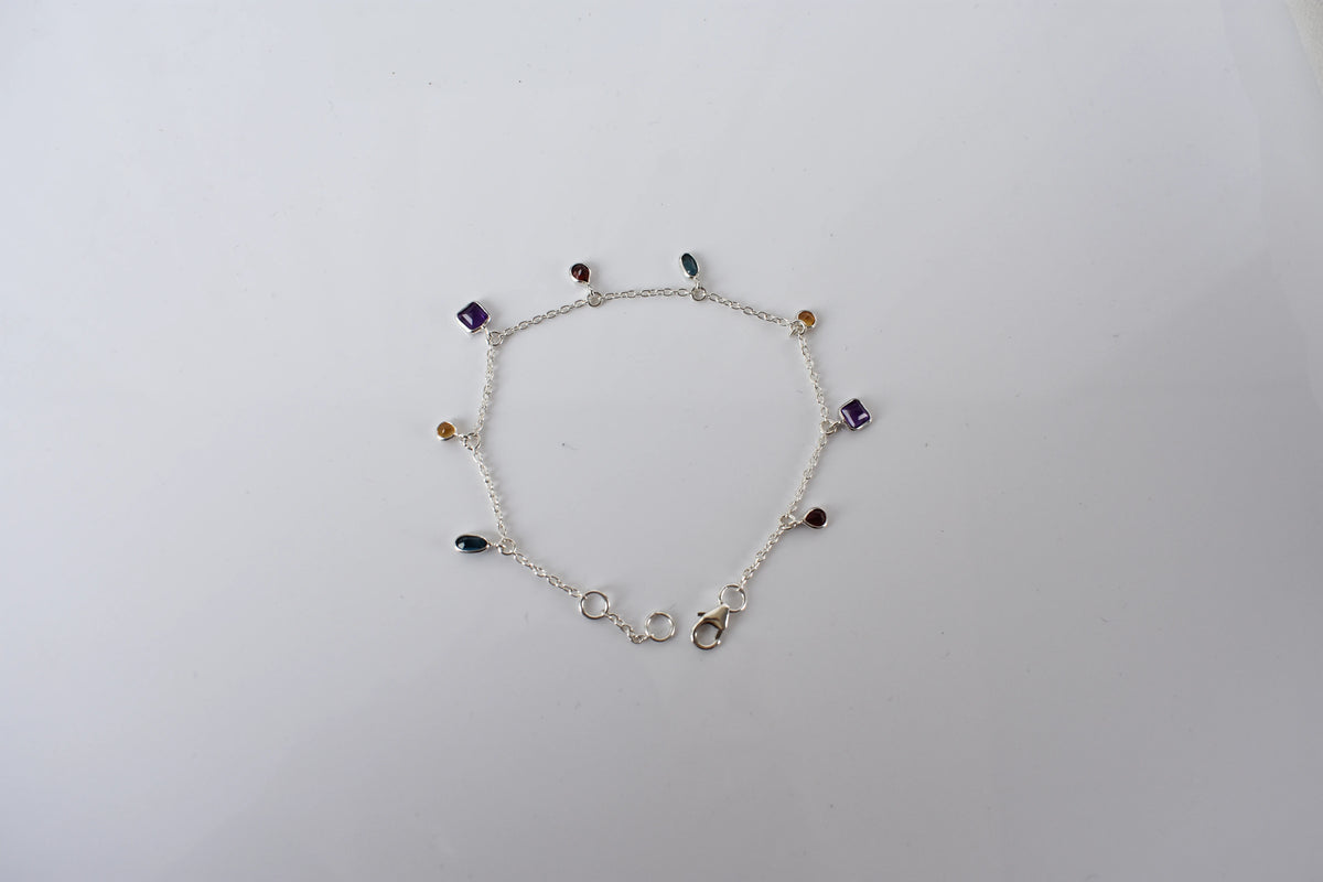 Multi gemstone charm bracelet with mixed-cut colored stones on a 925 silver chain