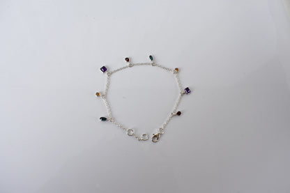Multi gemstone charm bracelet with mixed-cut colored stones on a 925 silver chain